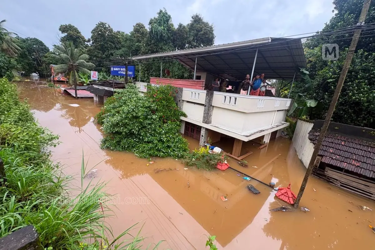 Residents remain on the upper floor of their house after floodwaters entered their home at Ittiyappara in Ranni, Pathanamthitta.