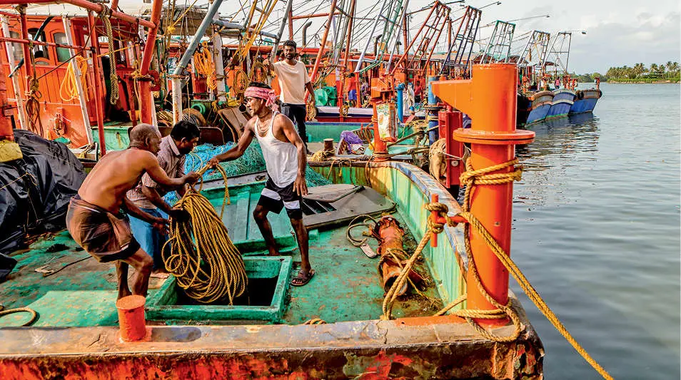 Workers prepare fishing boats for their return to sea after the trawling ban at Shaktikulangara, Kollam