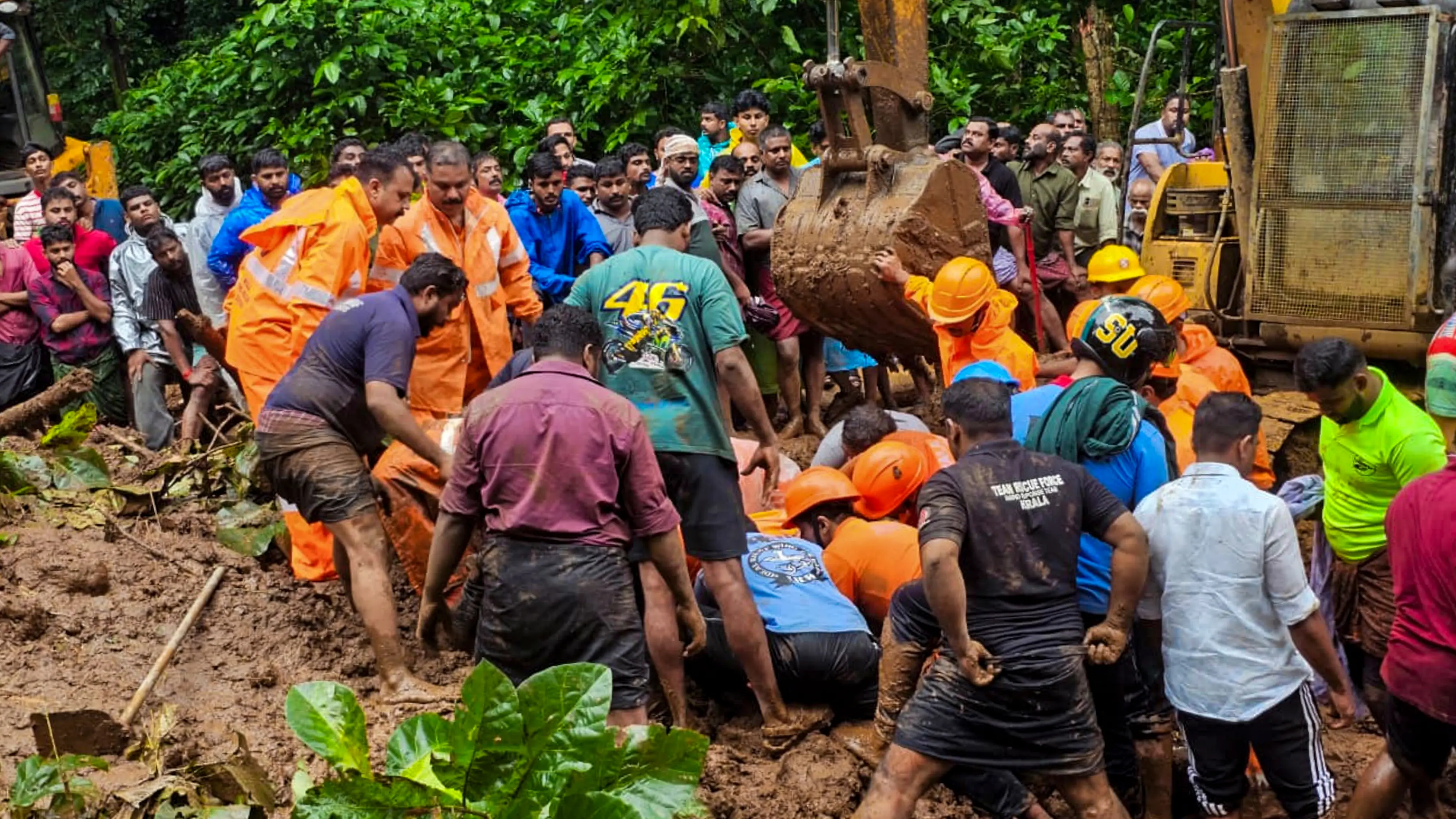 Rescue personnel and people during a rescue operation following a landslide due to rain-triggered floods | PTI