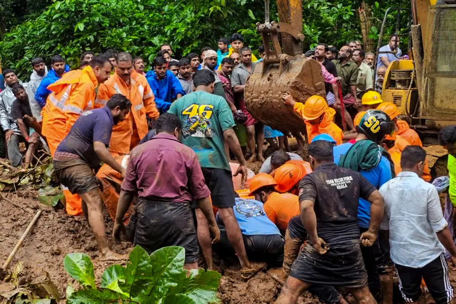 Rescue personnel and people during a rescue operation following a landslide due to rain triggered floods