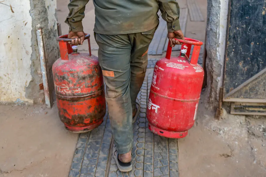 Catering workers struggling with empty commercial gas cylinders, highlighting the current fuel crisis in the industry