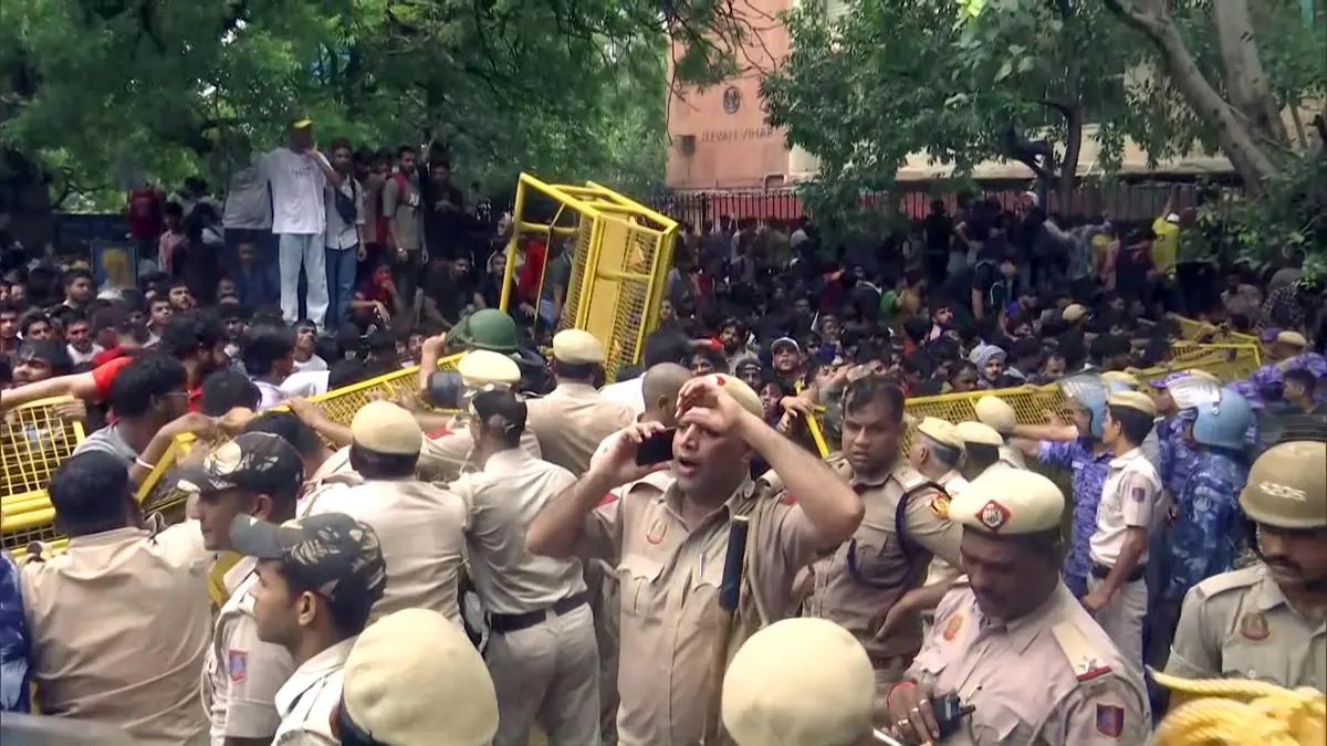 Police try to stop protestors during the protest by Cockroach Janta Party, in New Delhi on Monday. (ANI Video Grab)