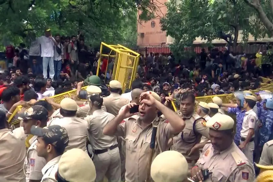 Police try to stop protestors during the protest by Cockroach Janta Party, in New Delhi on Monday. (ANI Video Grab)