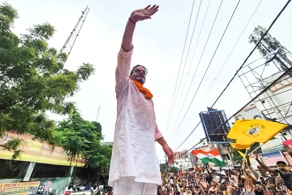 Jan Suraaj Party (JSP) founder Prashant Kishor waves at party workers during a victory march