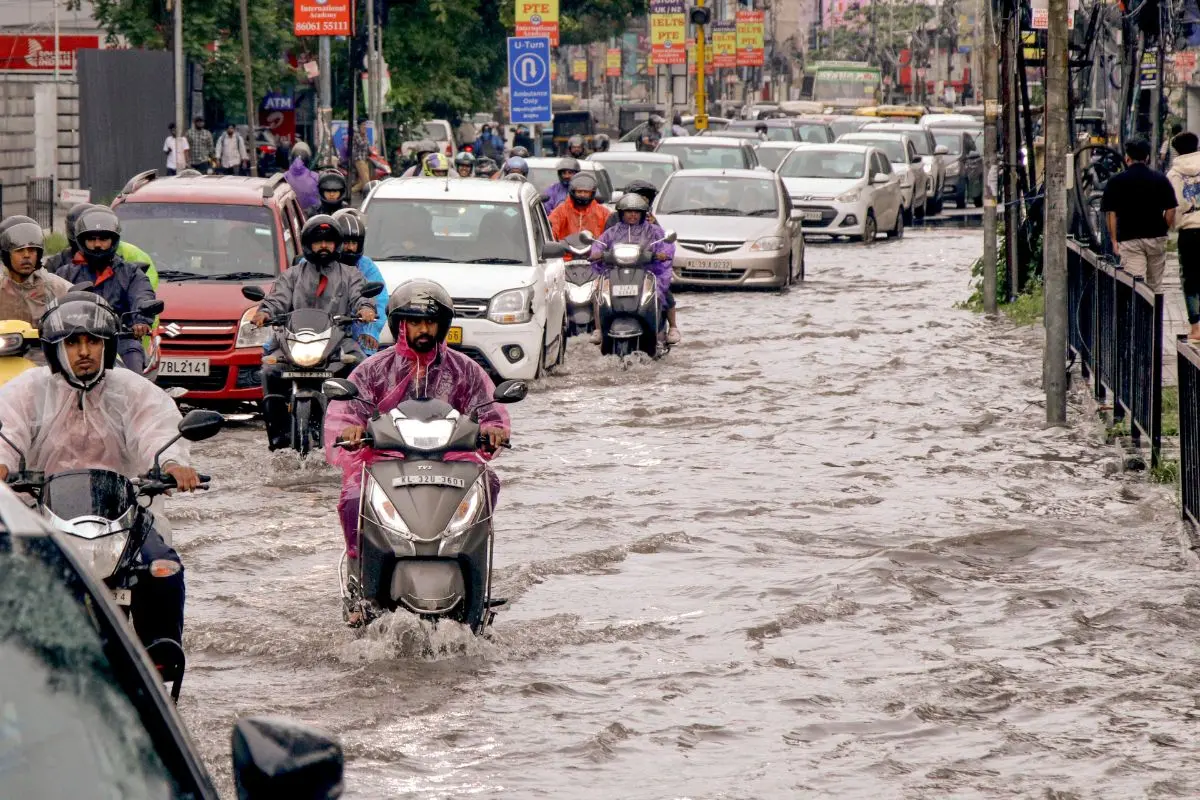 Commuters move through a waterlogged road after heavy rainfall, in Kochi, Kerala (File photo: PTI)