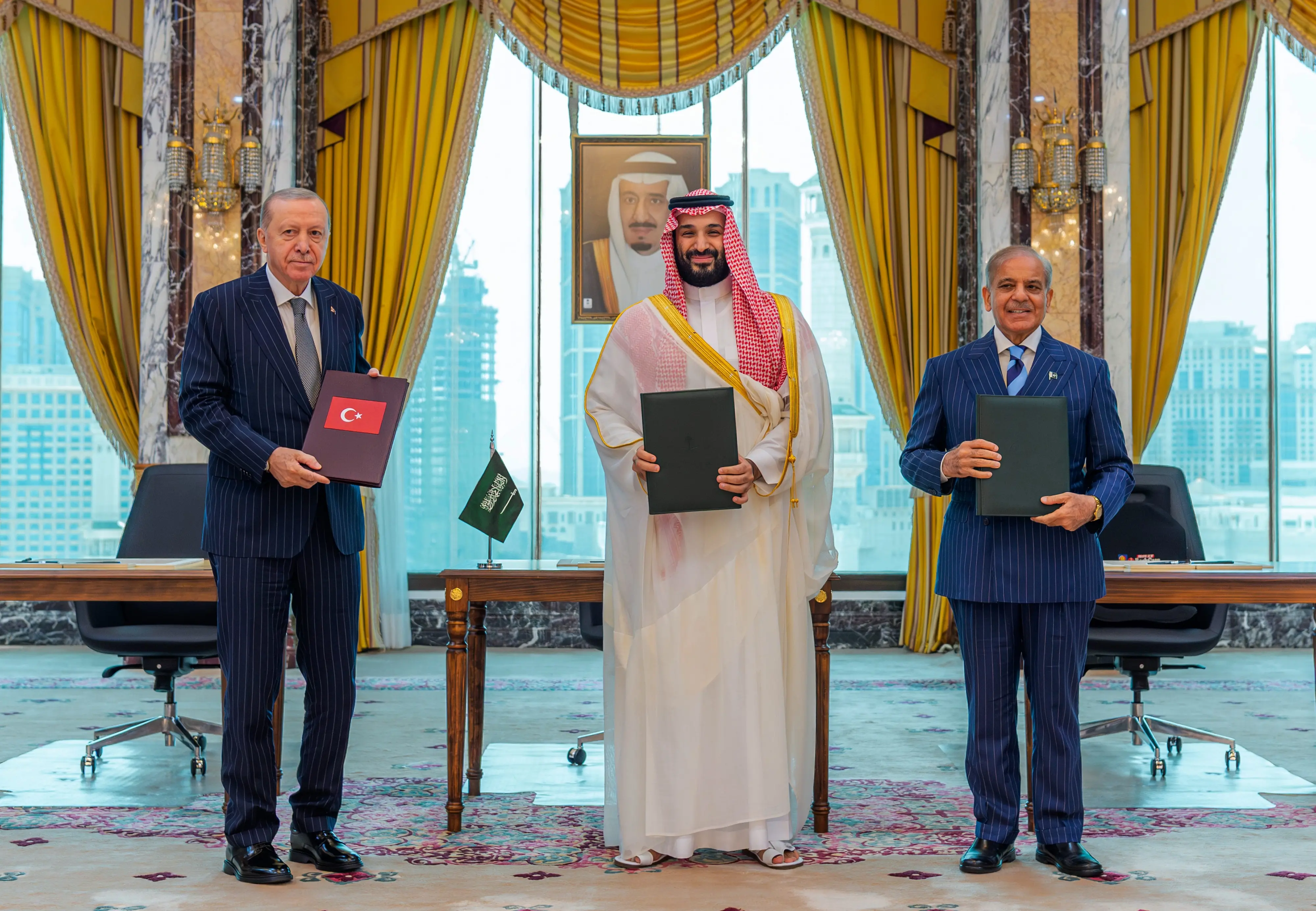 From left, Turkish President Recep Tayyip Erdogan, Saudi Crown Prince Mohammed bin Salman and Pakistani Prime Minister Shehbaz Sharif pose after signing a trilateral defense agreement in Mecca, Saudi Arabia