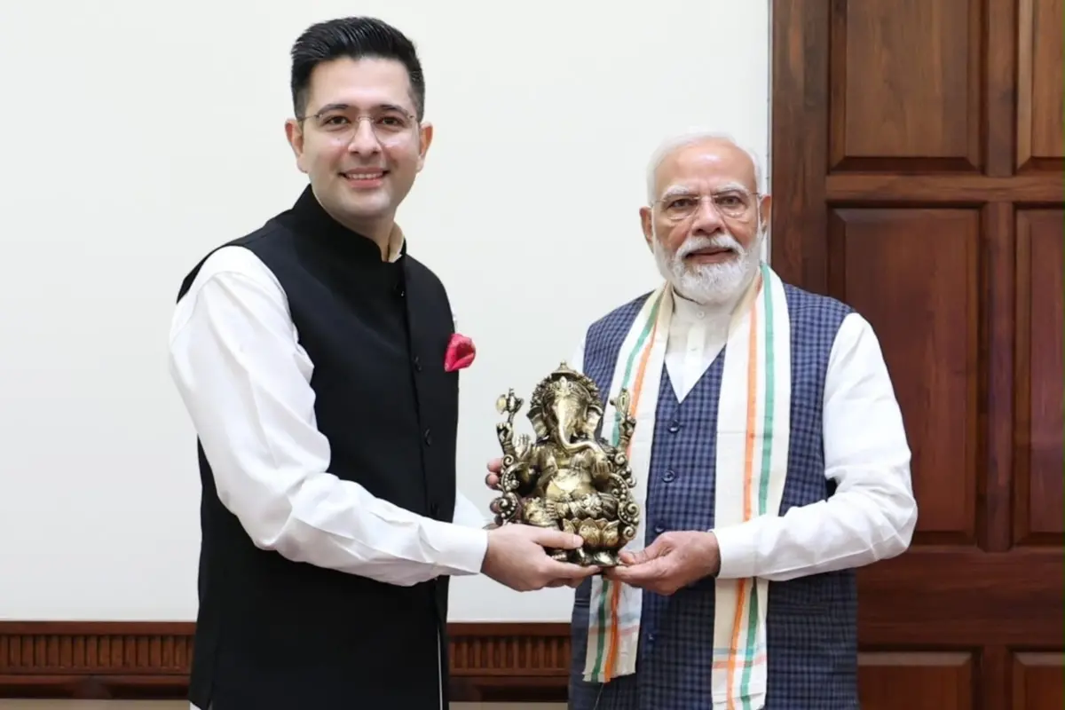 Prime Minister Narendra Modi being greeted by BJP MP Raghav Chadha during a meeting.| Photo: X