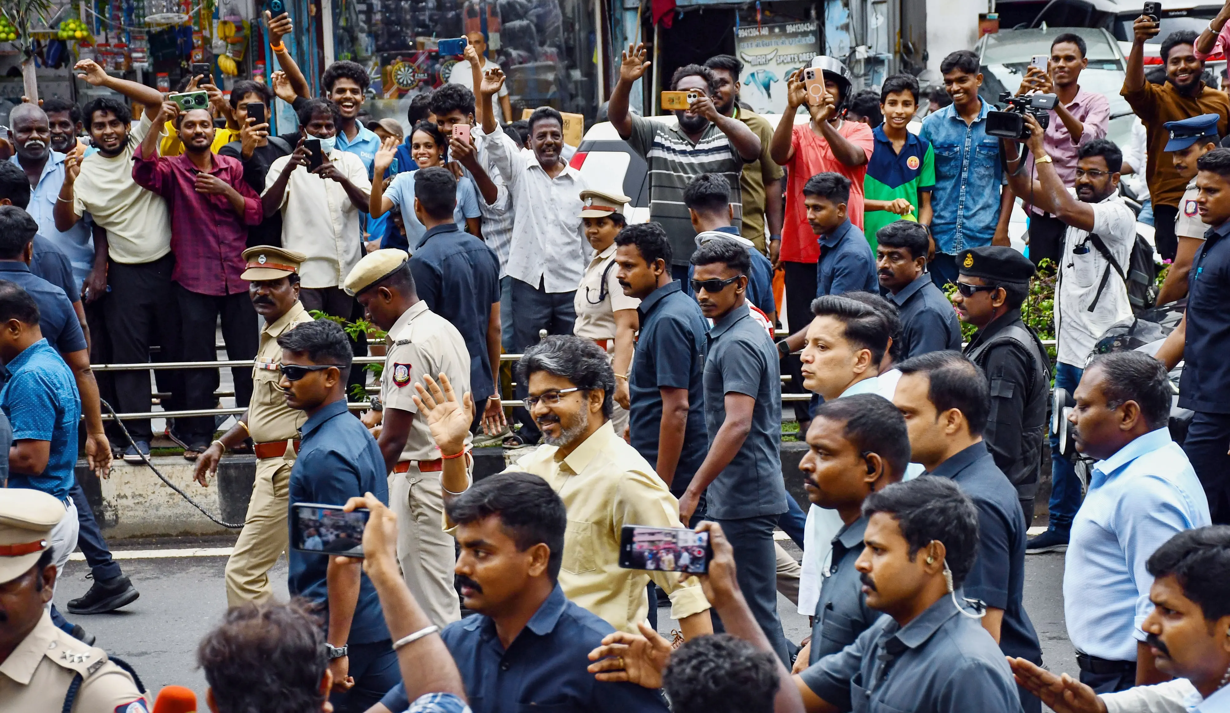 Tamil Nadu Chief Minister C Joseph Vijay waves to the people gathered on the road following a meeting of State MPs at Kalaivanar Arangam, in Chennai on Saturday | Photo: ANI