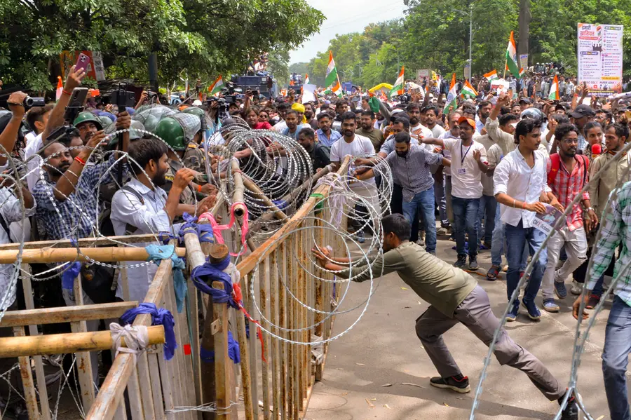 Security personnel stand guard as people march towards Jharkhand Assembly