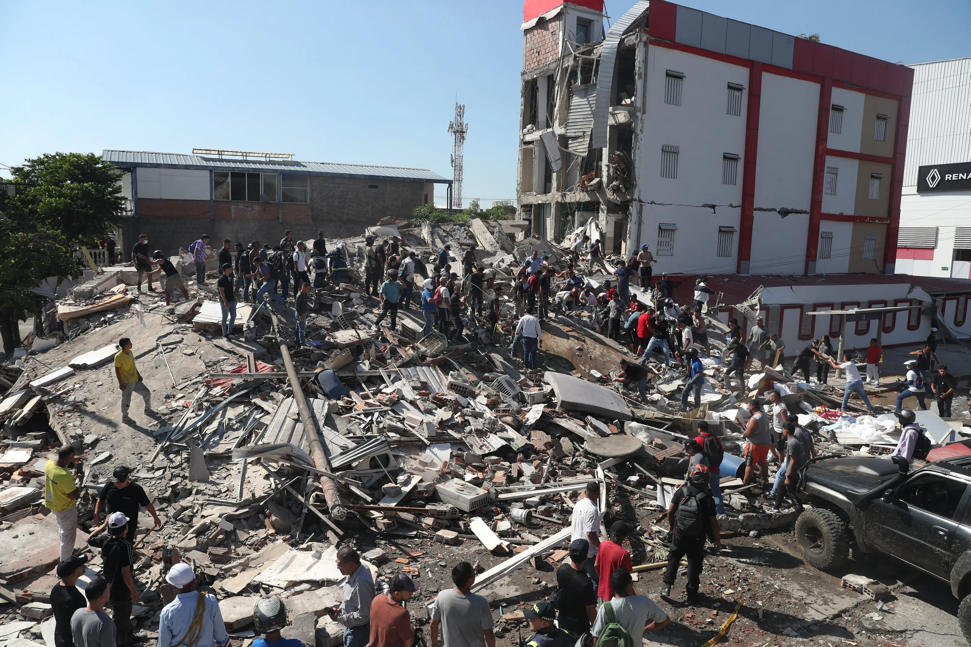 Residents and rescue workers search through the rubble of a collapsed building after an earthquake struck Cali, Colombia.| Photo: PTI