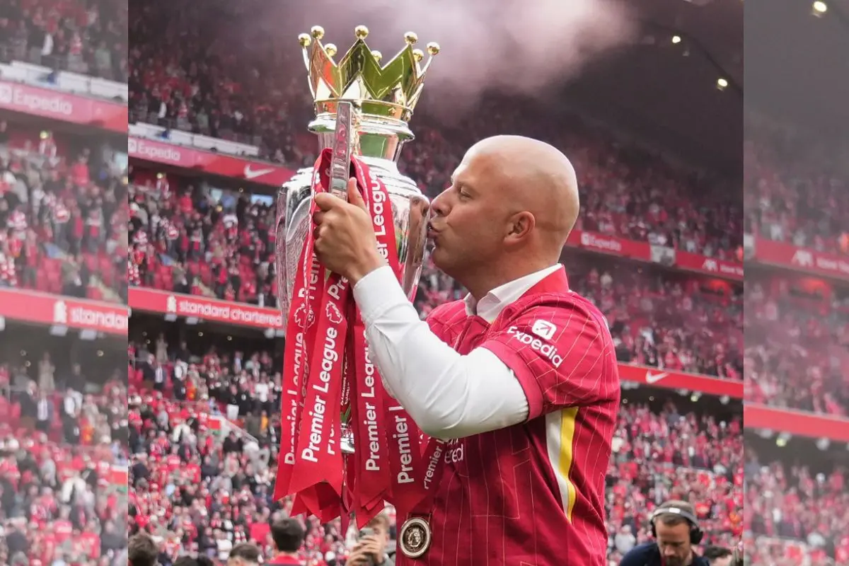 Arne Slot kisses the EPL winners' trophy as the Liverpool coach. | File Photo: AP/PTI