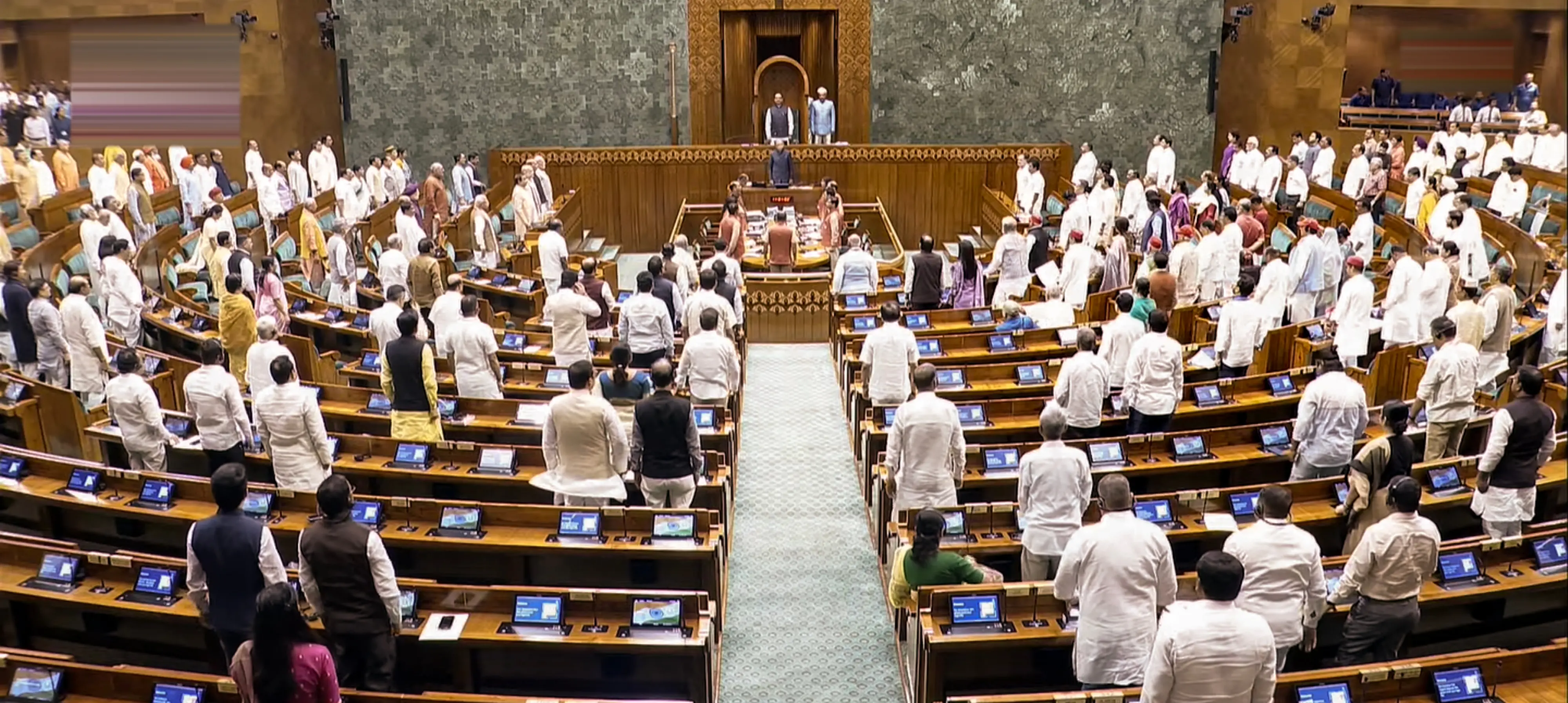 Members of Parliament stand at attention during the rendition of 'Vande Mataram' in Lok Sabha during the Monsoon session of Parliament, in New Delhi.| Photo: PTI
