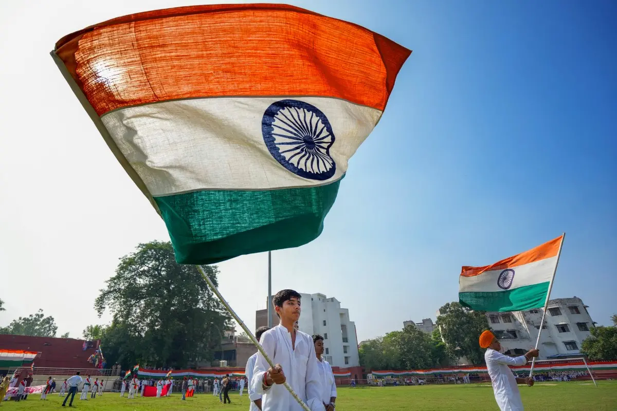 A student waves the national flag during the full-dress rehearsal for the 80th Independence Day | Photo: PTI