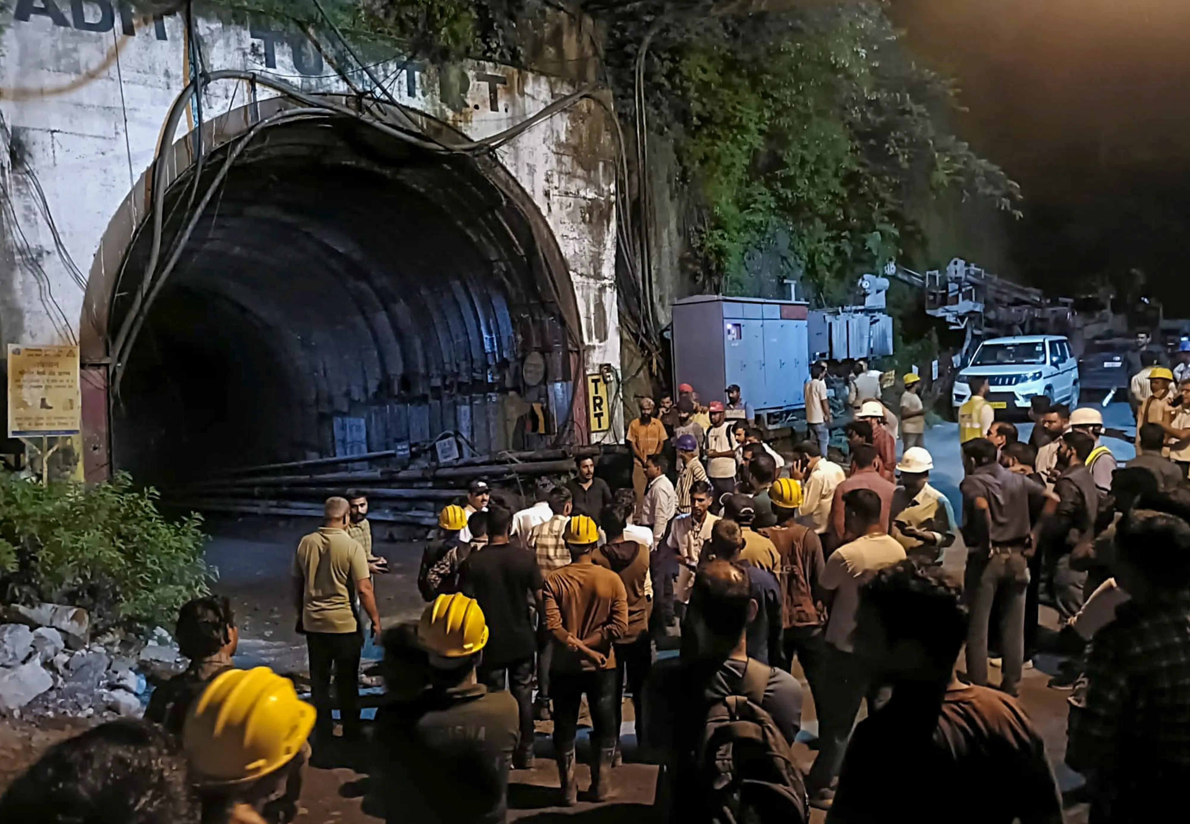People gather after a landslide in an under-construction tunnel of the Vishnugad-Pipalkoti Hydroelectric Project, in Chamoli district, Uttarakhand