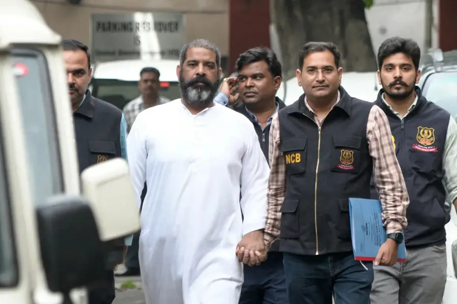 NCB officials escorting international drug syndicate mastermind Virender Baisoya after extradition from Dubai