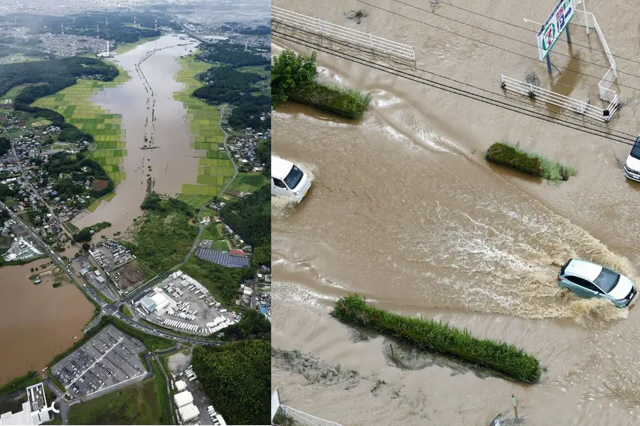Floodwaters inundate an area in Sakura, Chiba prefecture-Cars make their way through flooded road after heavy rain in Oamishirasato