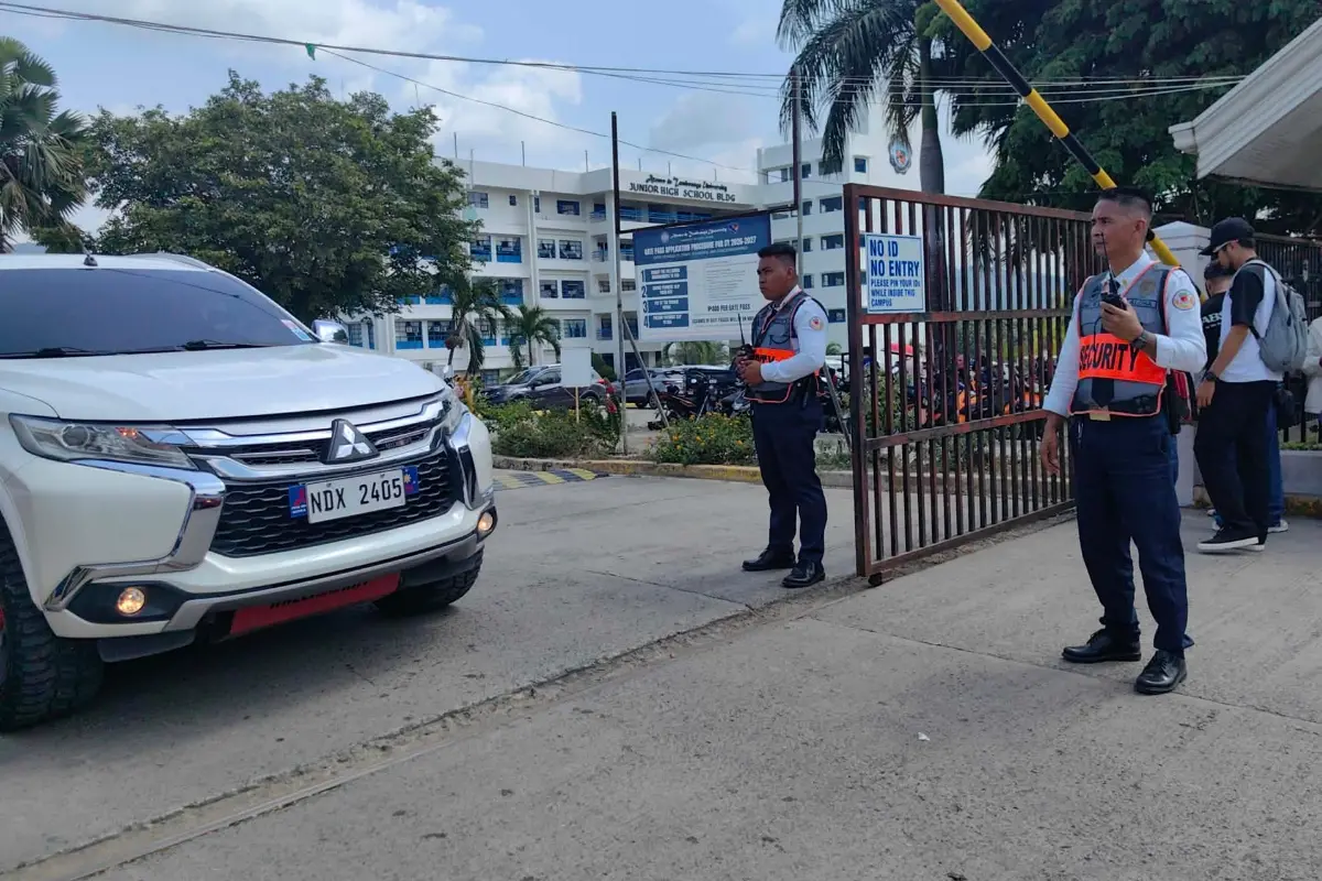Security guards keep watch as vehicles exit the Ateneo de Zamboanga University following a shooting incident in Zamboanga, southern Philippines | Photo: AP/PTI