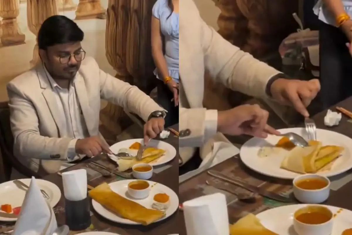 Eating dosa with a fork and spoon