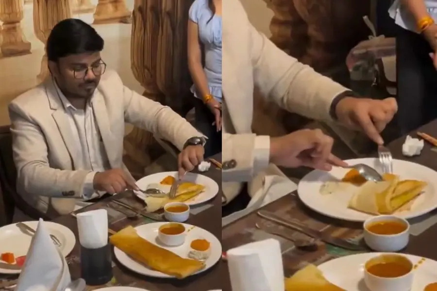 Eating dosa with a fork and spoon