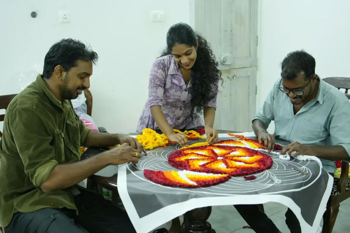 Adith, Ashith and Nandana at work on a floral carpet