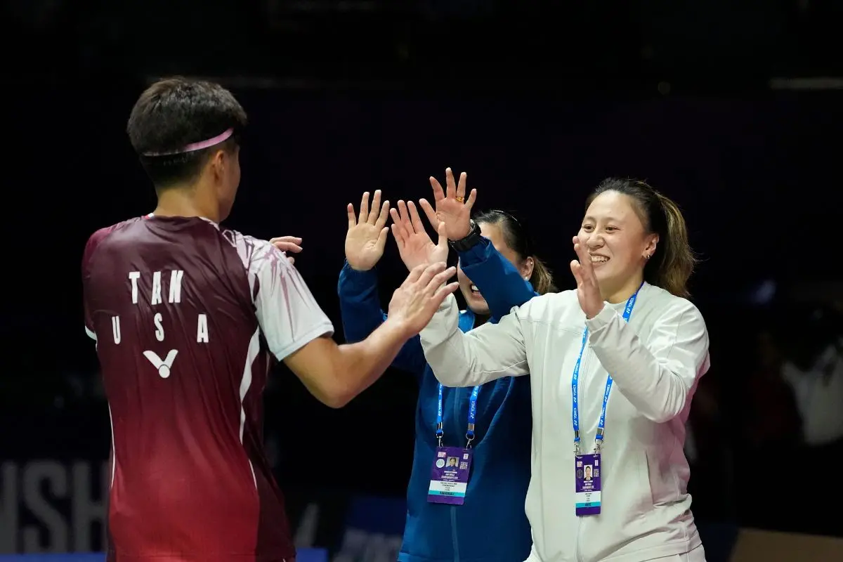 United States' Garret Tan celebrates with the members of his support staff after defeating India's Lakshya Sen at the Badminton World Championships in New Delhi, India, Wednesday, Aug. 19, 2026. (AP Photo/Manish Swarup)