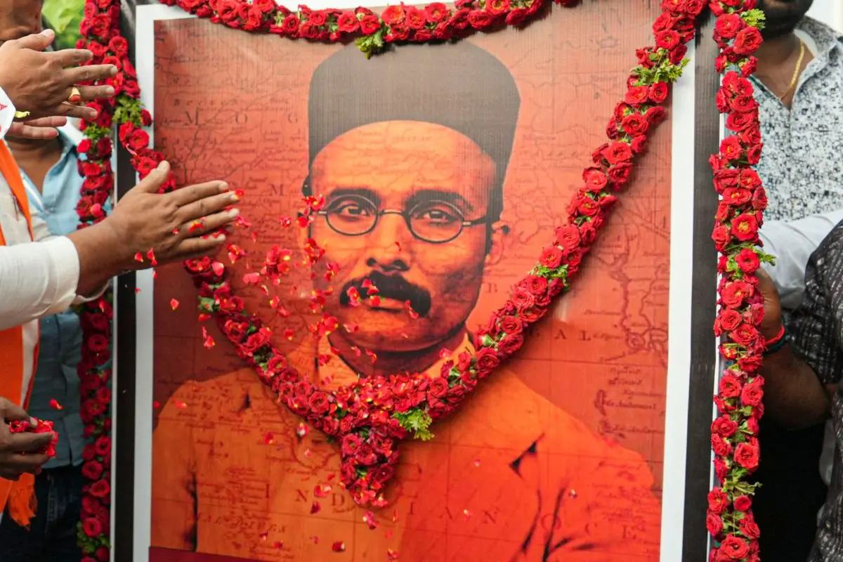 Floral tribute at a poster of V.D. Savarkar | File photo: PTI