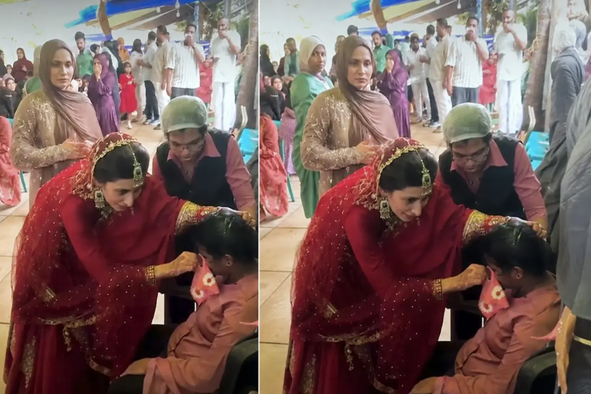 Dressed as a bride, Keralam doctor Dr Shirin Subair provides first aid to a catering worker who fell ill at her wedding in Kannur. (Screengrab: MBI)