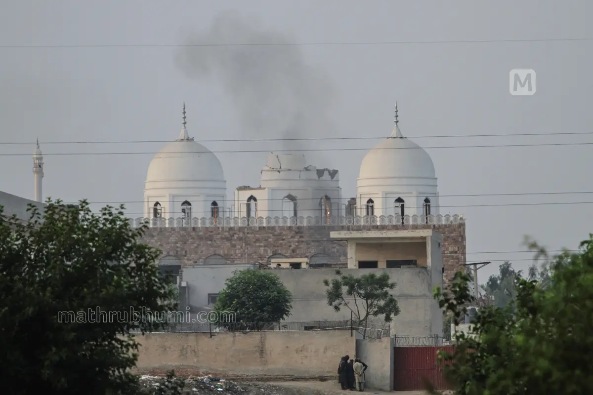 Local residents stand outside a mosque of an Islamic seminary partially damaged by a suspected Indian missile attack, outskirts of Bahawalpur
