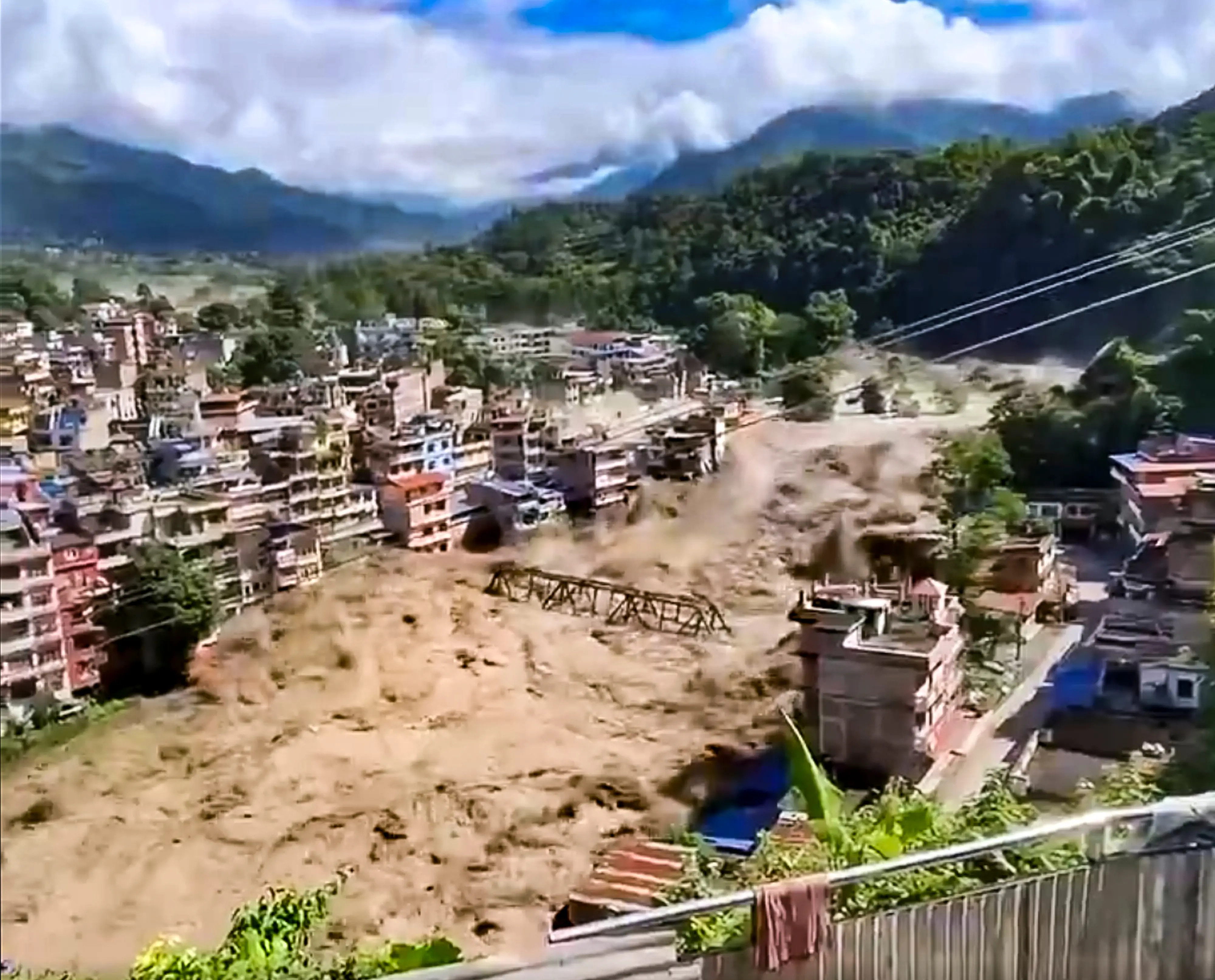 Floodwater flows across a residential area in Nepal