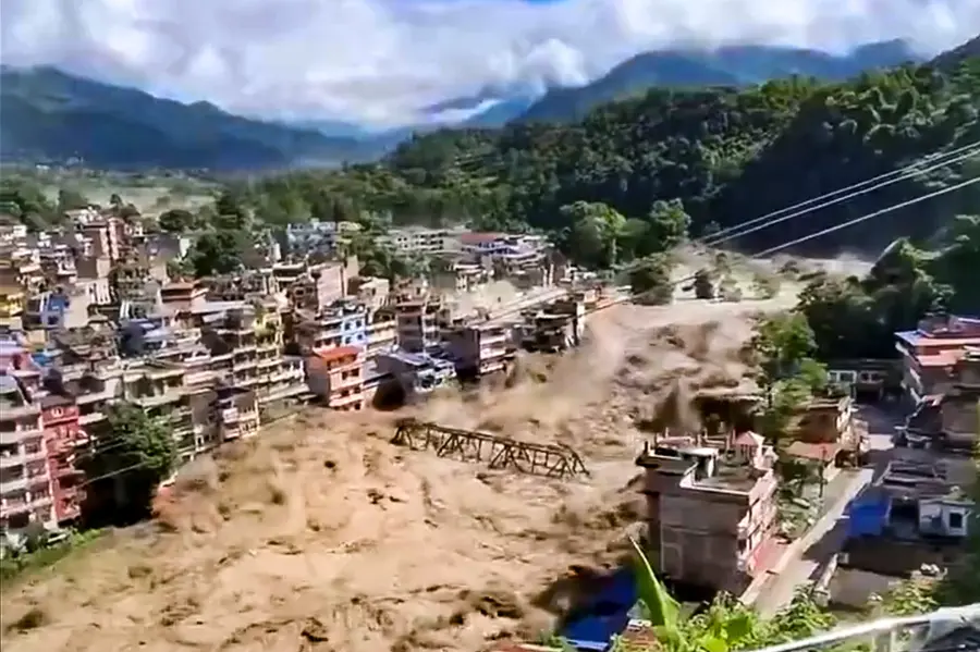 Floodwater flows across a residential area in Nepal