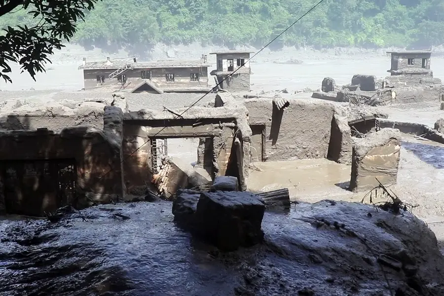 Houses and other structure devastated by mud-laden floodwaters following a flash flood caused by an outburst in the Bhotekoshi River