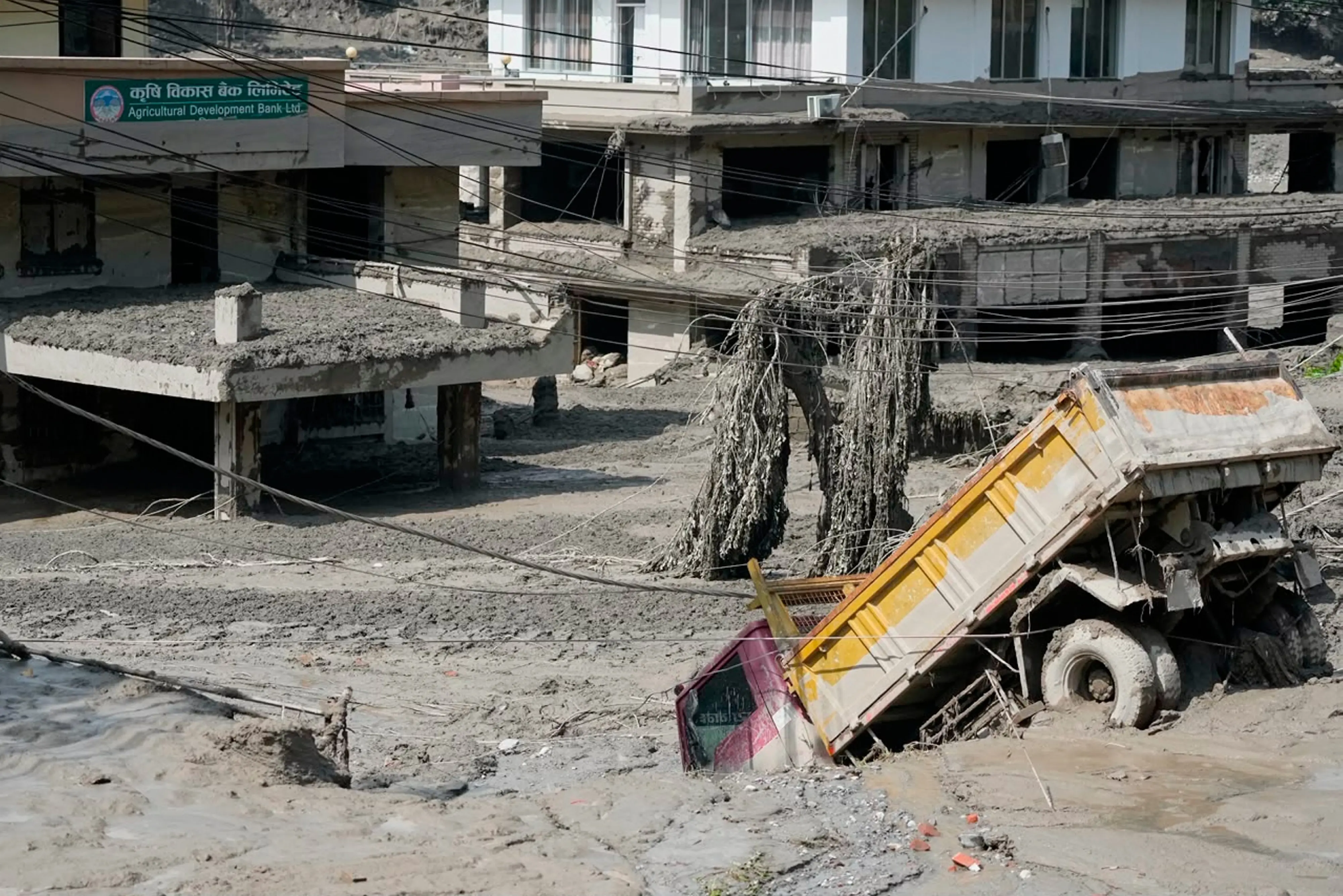 Damaged houses and vehicles are seen in the aftermath of flash floods along the Trishuli River in Nepal's Nuwakot district | PTI