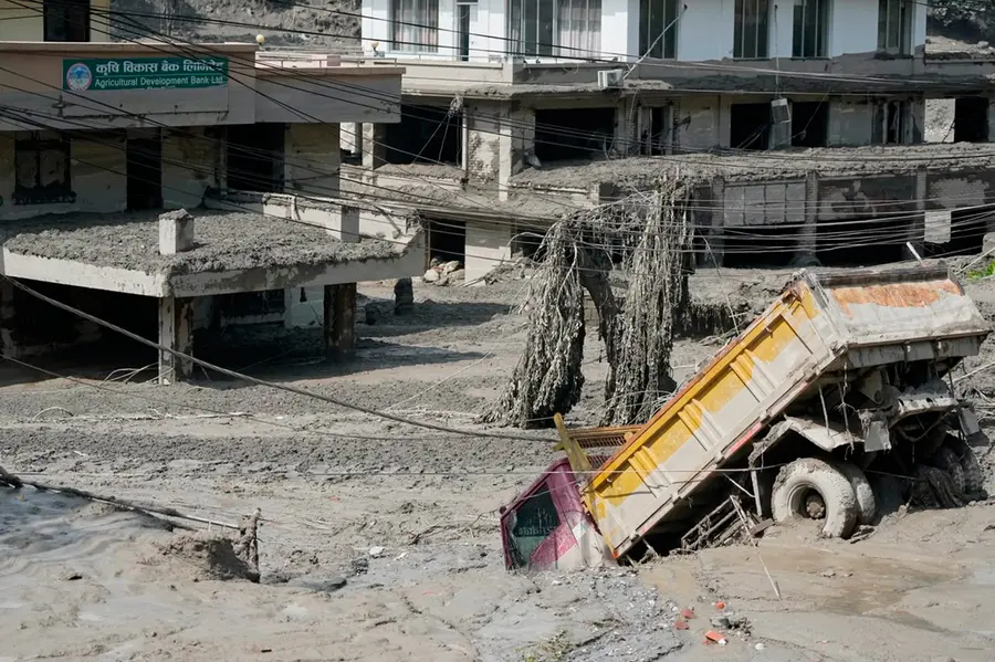 Damaged houses and vehicles are seen in the aftermath of flash floods along the Trishuli River in Nepal's Nuwakot district