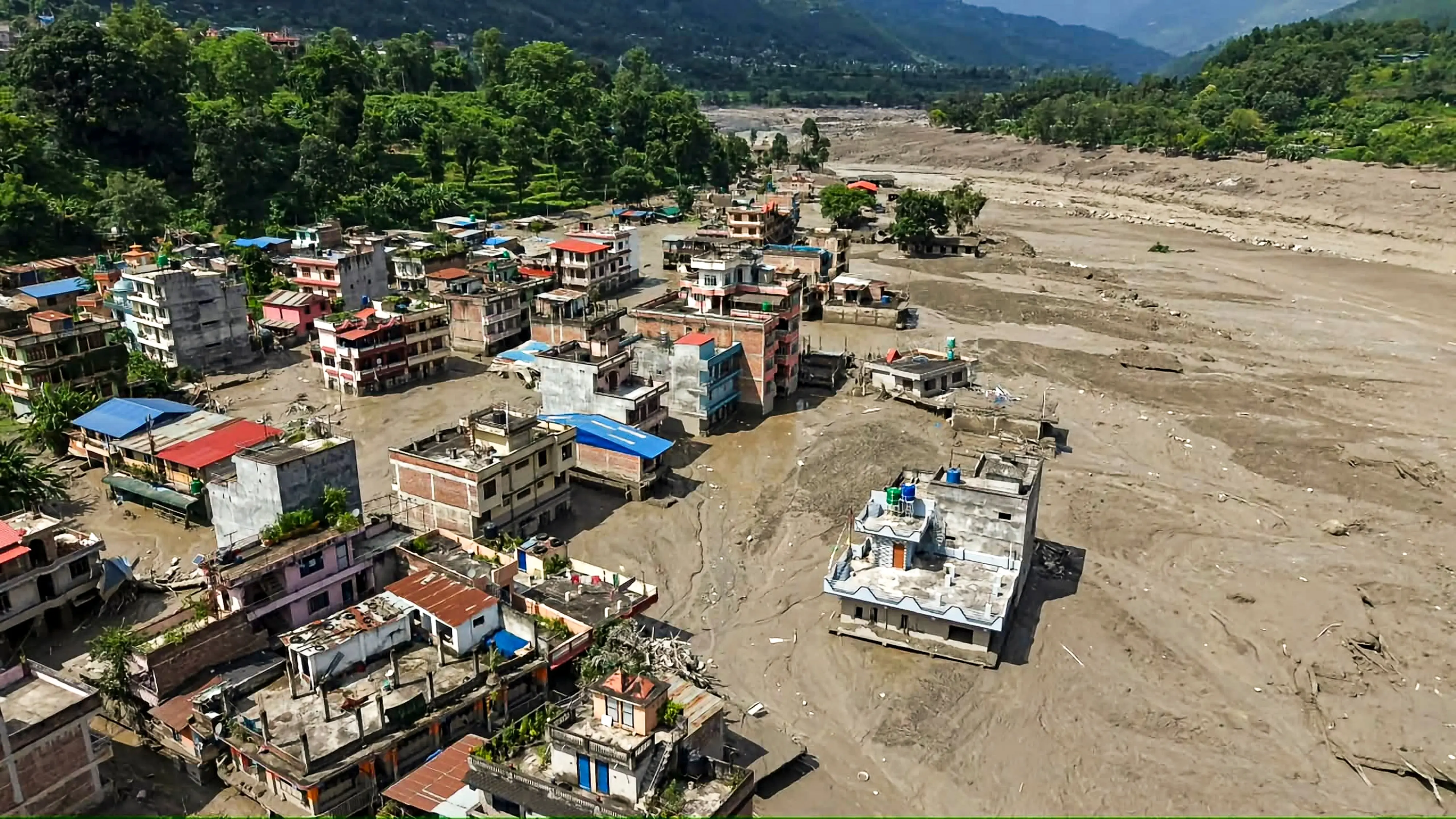 A view of structures standing partially submerged in a thick layer of mud and debris following flash floods at Beni Ghat area | PTI