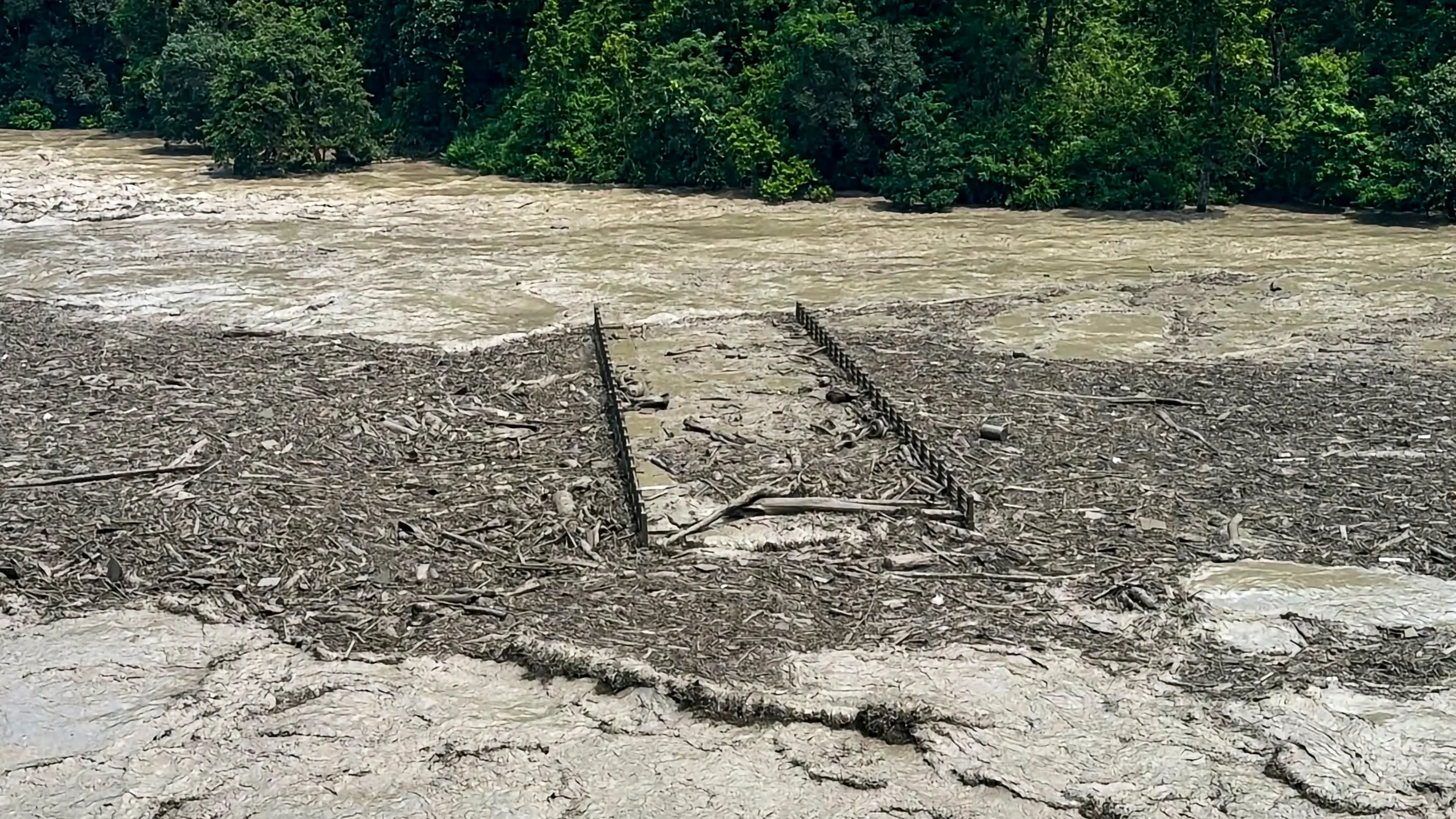A view of massive debris and thick mud completely submerging a suspension bridge following the flash floods at Beni Ghat area | PTI