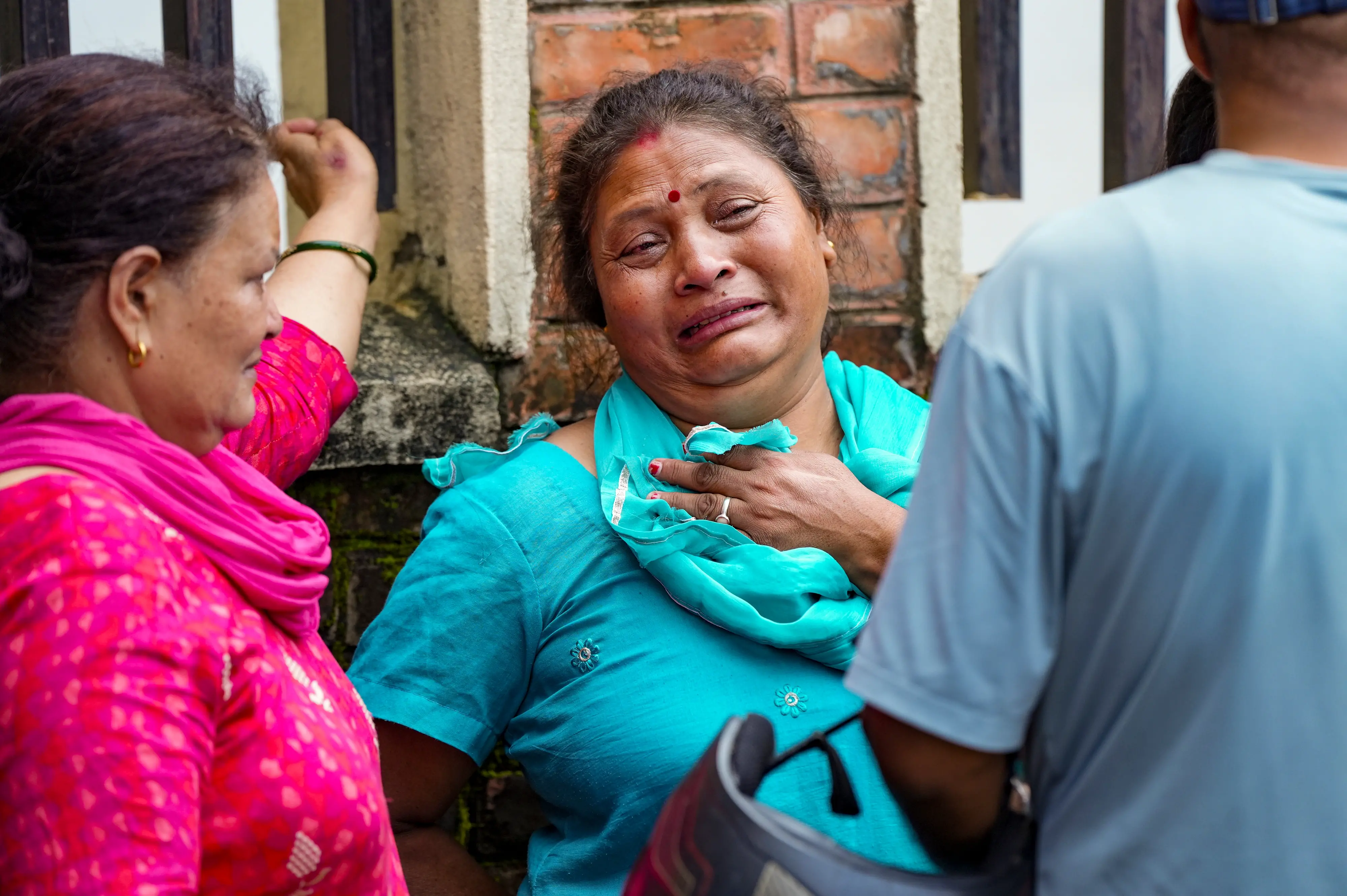 Family members and relatives mourn outside a hospital mortuary after identifying their loved ones who died in the flash floods in Kathmandu of Nepal, on Saturday, Aug 29, 2026. | Photo: PTI