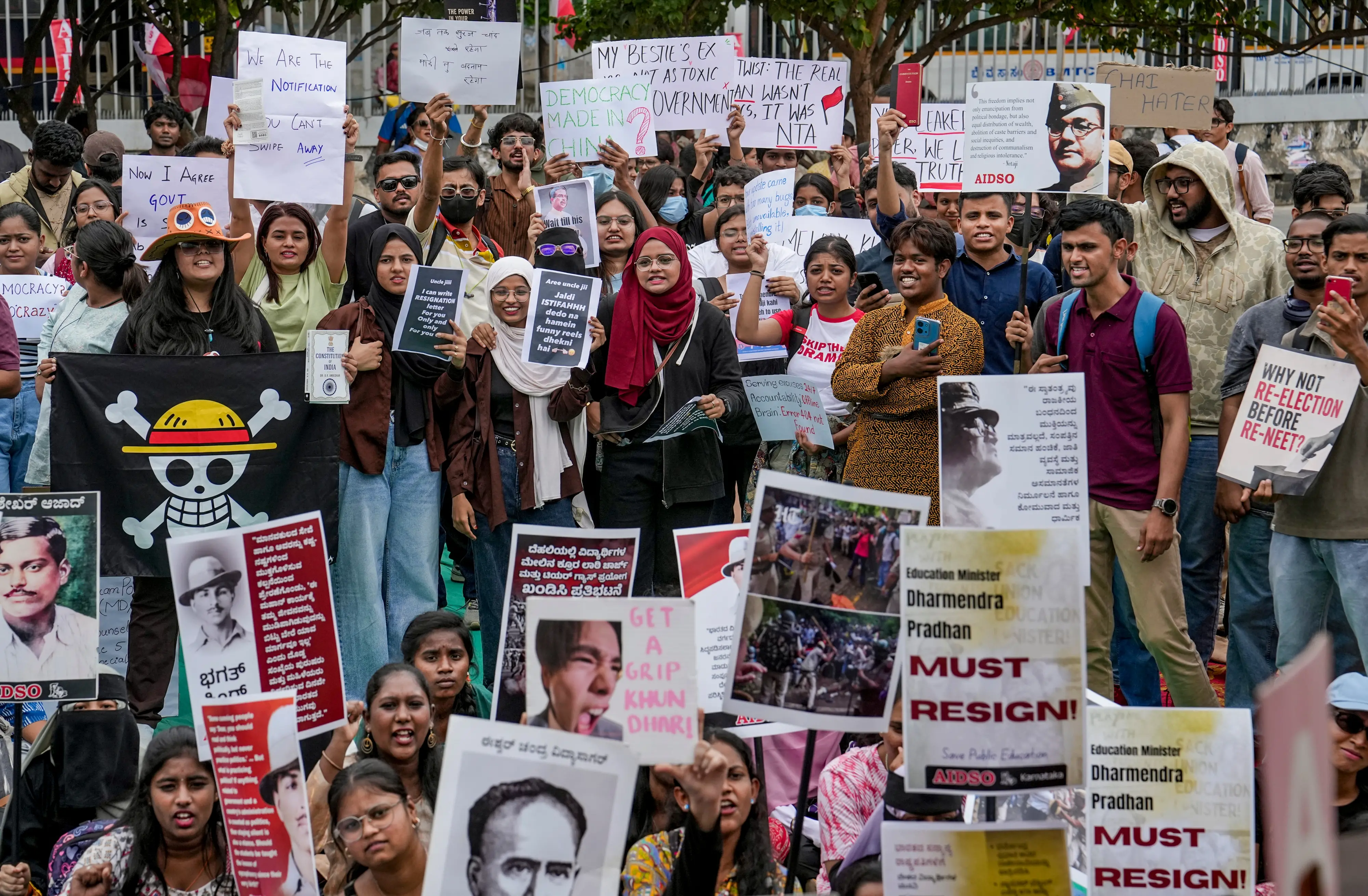 Members of the All India Democratic Students' Organisation (AIDSO) hold placards during a protest demanding the resignation of Union Education Minister Dharmendra Pradhan over alleged irregularities in the NEET examination, in Bengaluru, Karnataka.| Photo: PTI