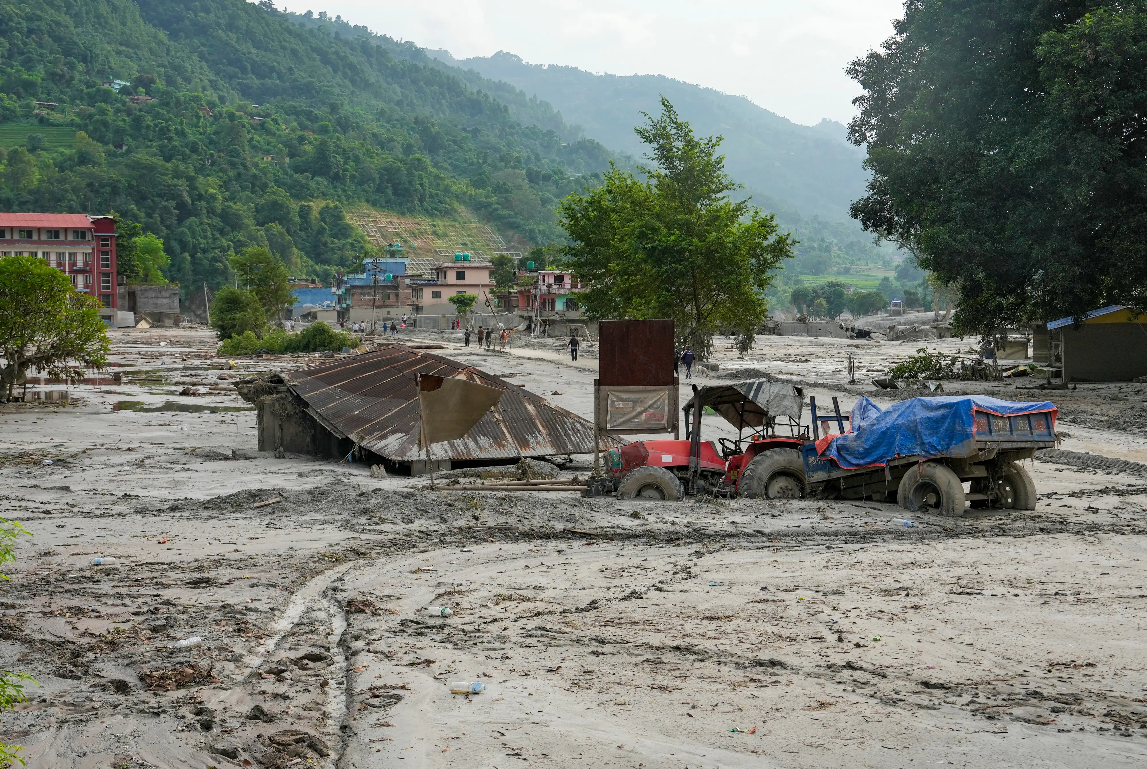A tractor and a structure partially submerged in mud following the devastating flash floods at Devighat village in Nuwakot district, Nepal | PTI