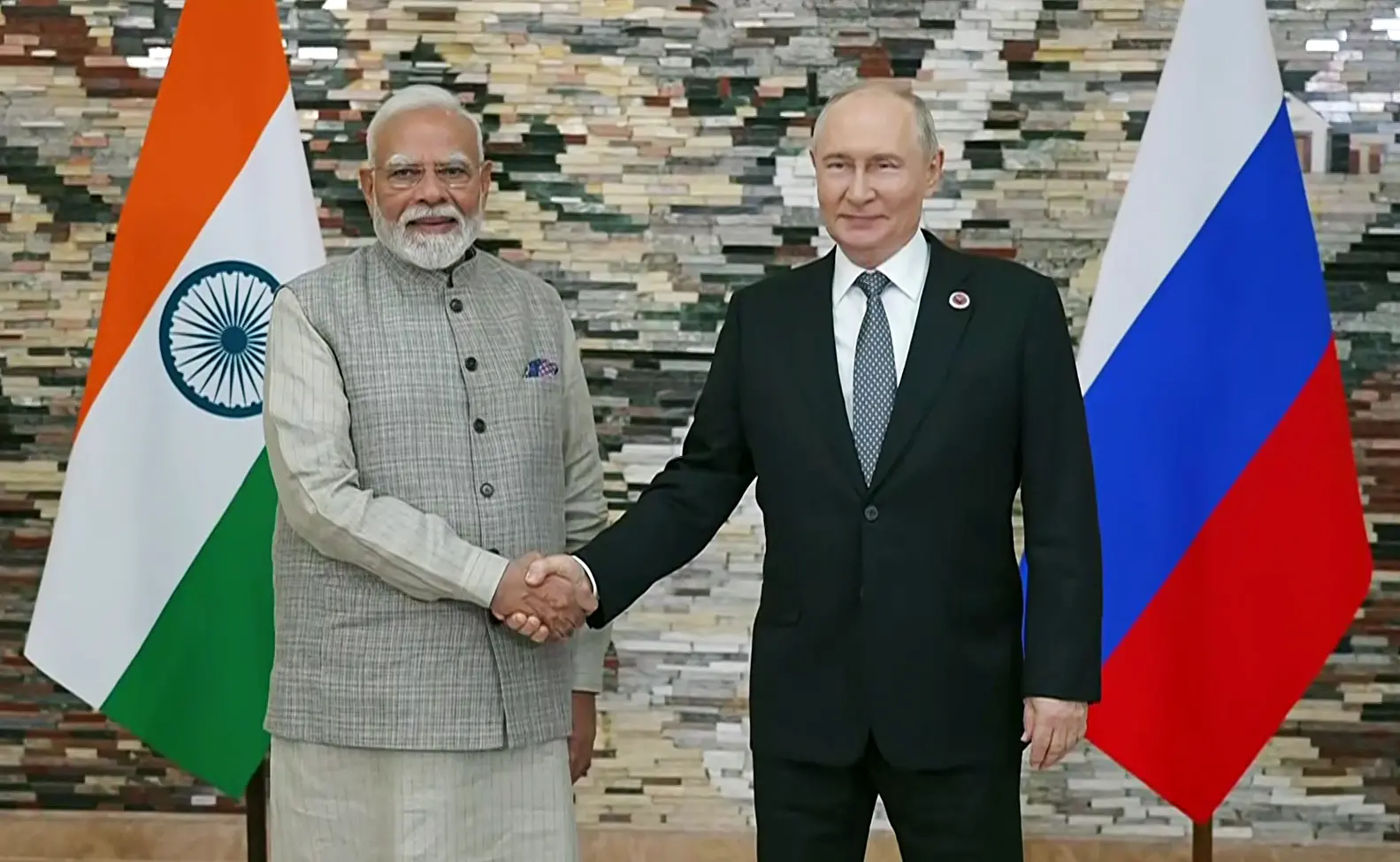 Prime Minister Narendra Modi and Russian President Vladimir Putin exchange a handshake ahead of their bilateral talks on the sidelines of the Shanghai Cooperation Organization (SCO) summit