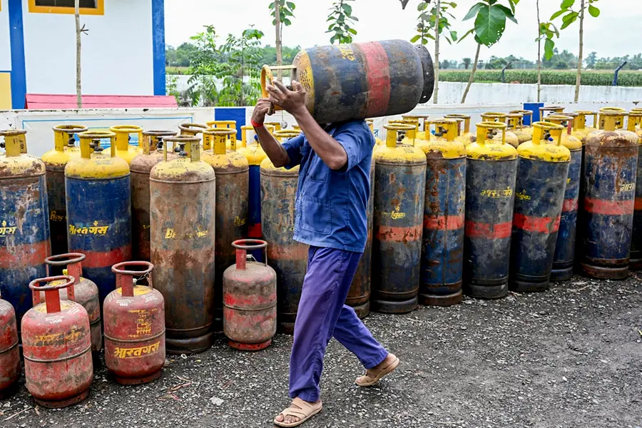 A worker stacks up a commercial LPG cylinder