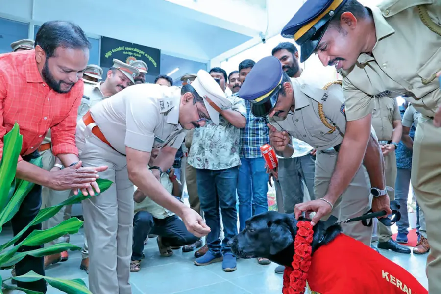 Kollam Rural SP Shaji Sugunan presenting birthday cake to police dog Arjun during 10th birthday celebration