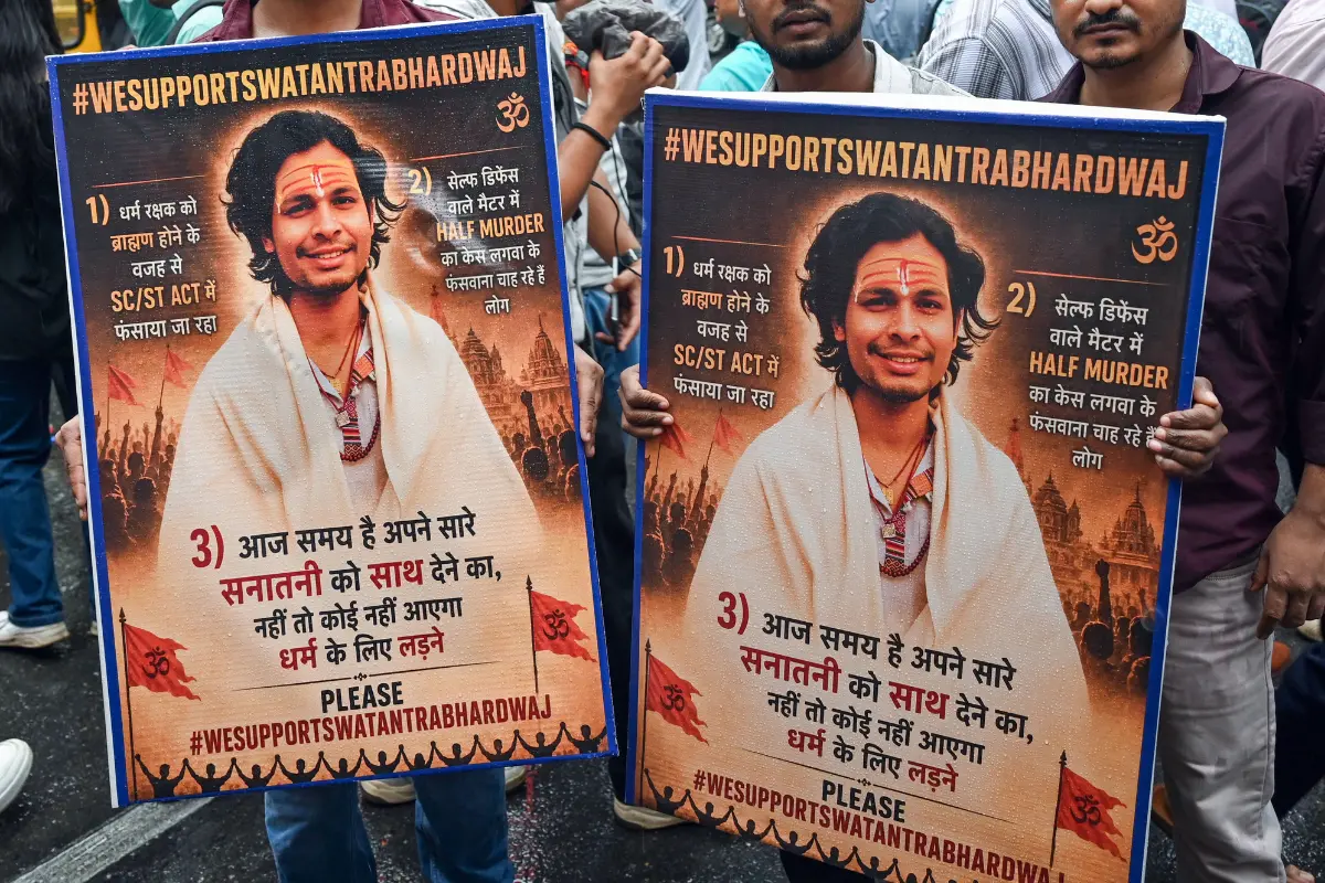 Supporters of the Hindutva influencer Swatantra Bhardwaj hold posters as they gather outside the Parliament Street Police Station following the latter's detention over the alleged assault on CJP protester Nishu Azad's father, Sanjay Azad, in New Delhi.| Photo: PTI