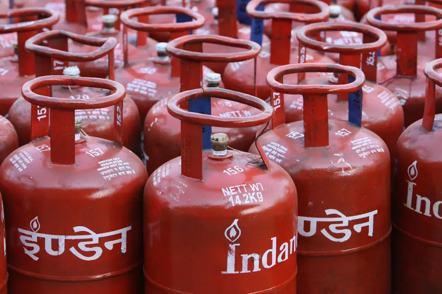 Red domestic LPG gas cylinders lined up for refill booking and distribution