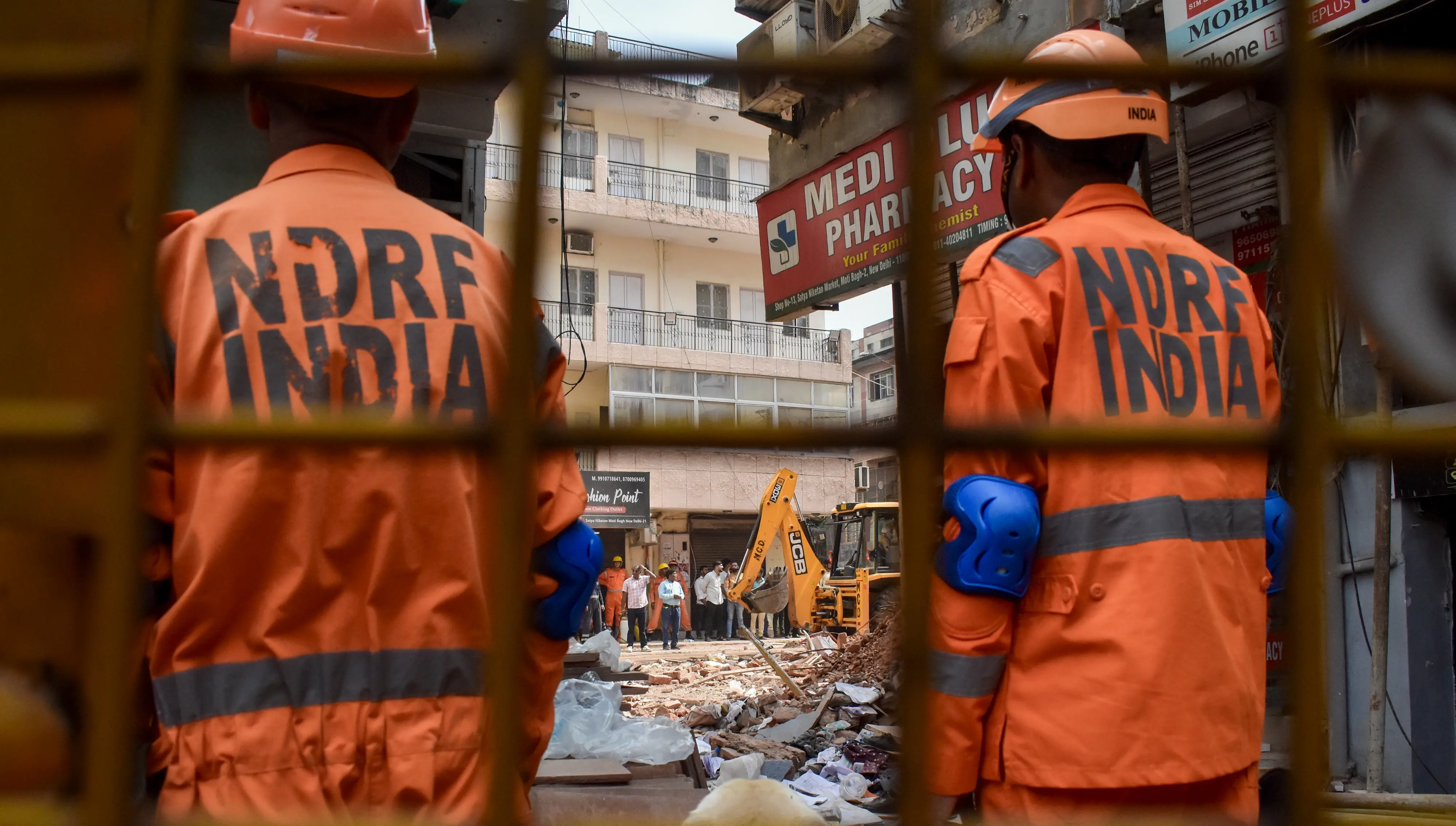 National Disaster Response Force (NDRF) personnel stand guard as search and rescue operations continue | PTI