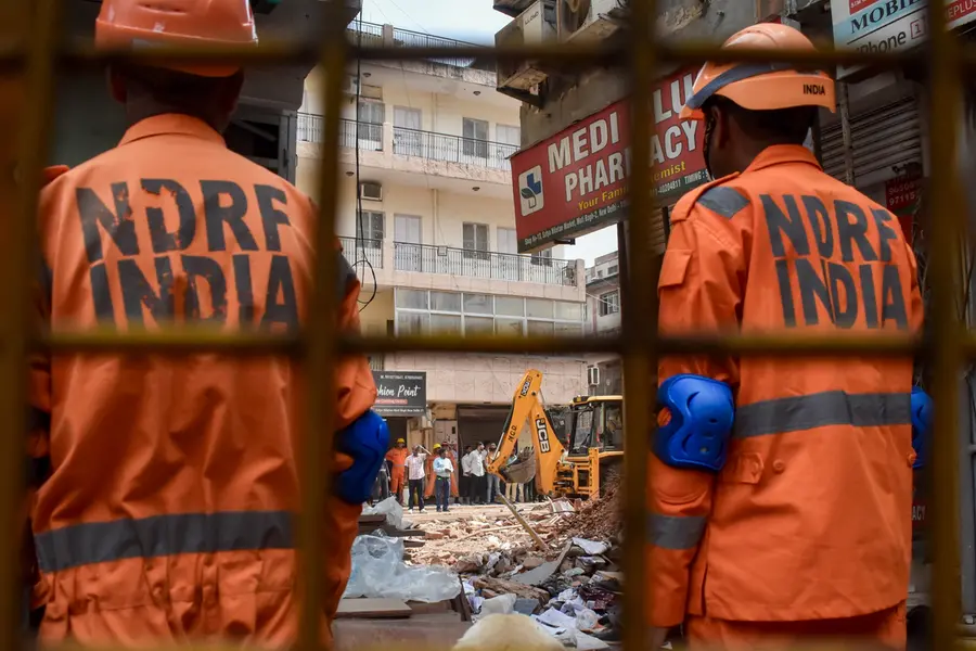 National Disaster Response Force (NDRF) personnel stand guard as search and rescue operations continue