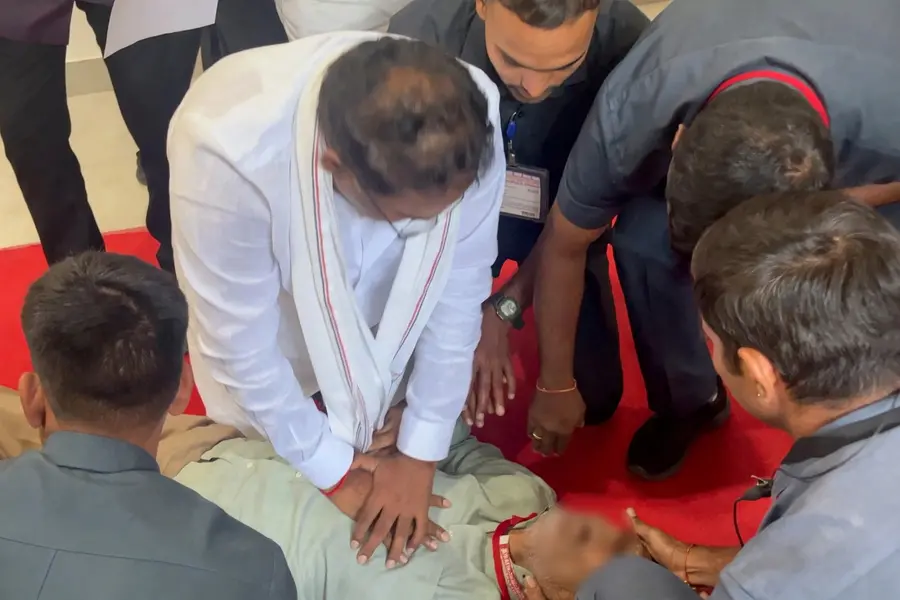 Telangana Minister Vakiti Srihari rendering emergency CPR to an official in the state Assembly corridor