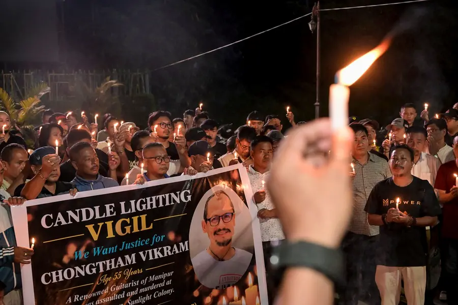 People participate in a candlelight vigil at the Western Gate of Kangla condemning the killing of Manipuri musician Chongtham Vikram Singh in New Delhi, in Imphal, Manipur,