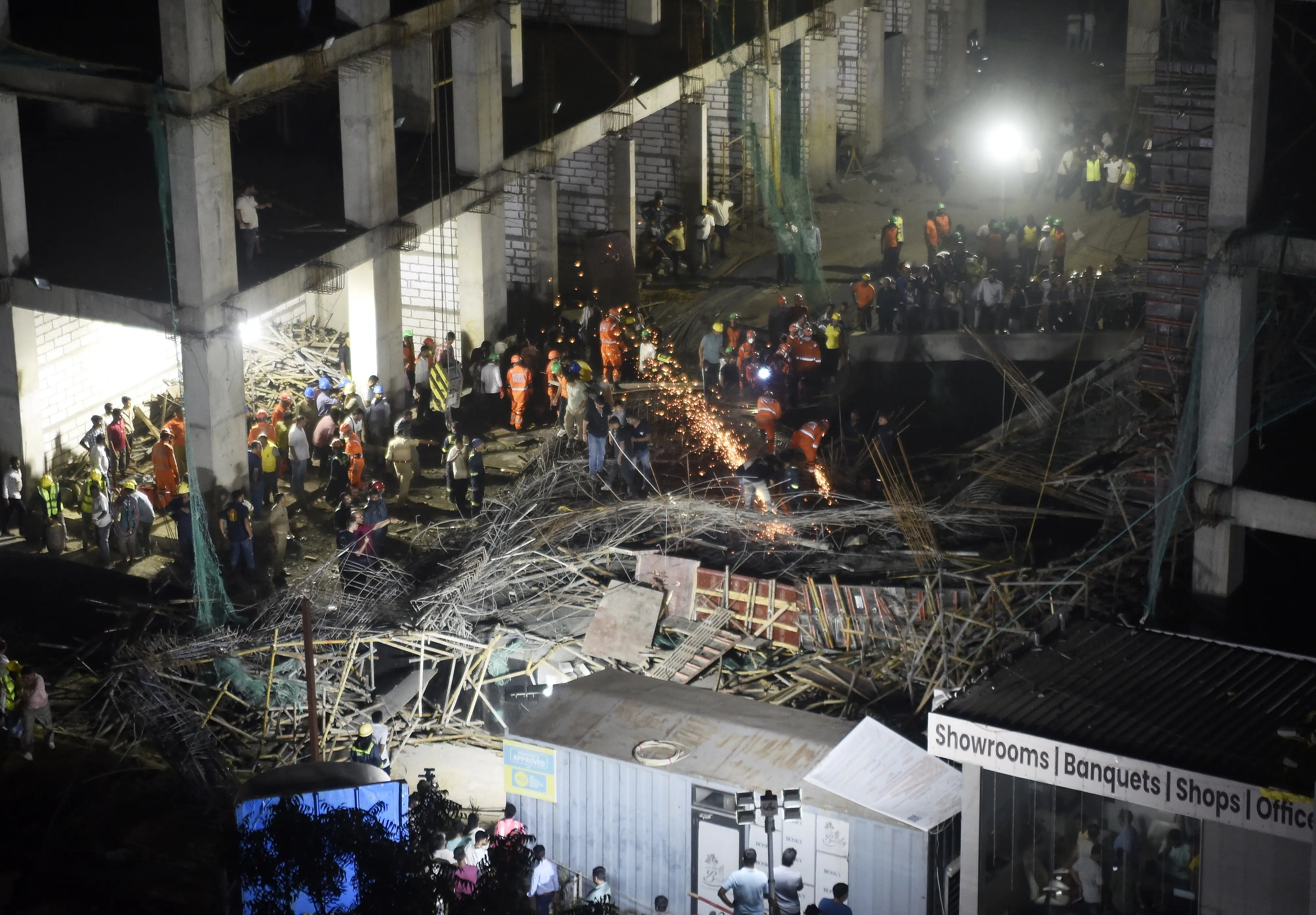 Officials conducting rescue operation after a metal slab collapsed at an under-construction site at Kudasan area, in Gandhinagar, Gujarat | Photo: PTI