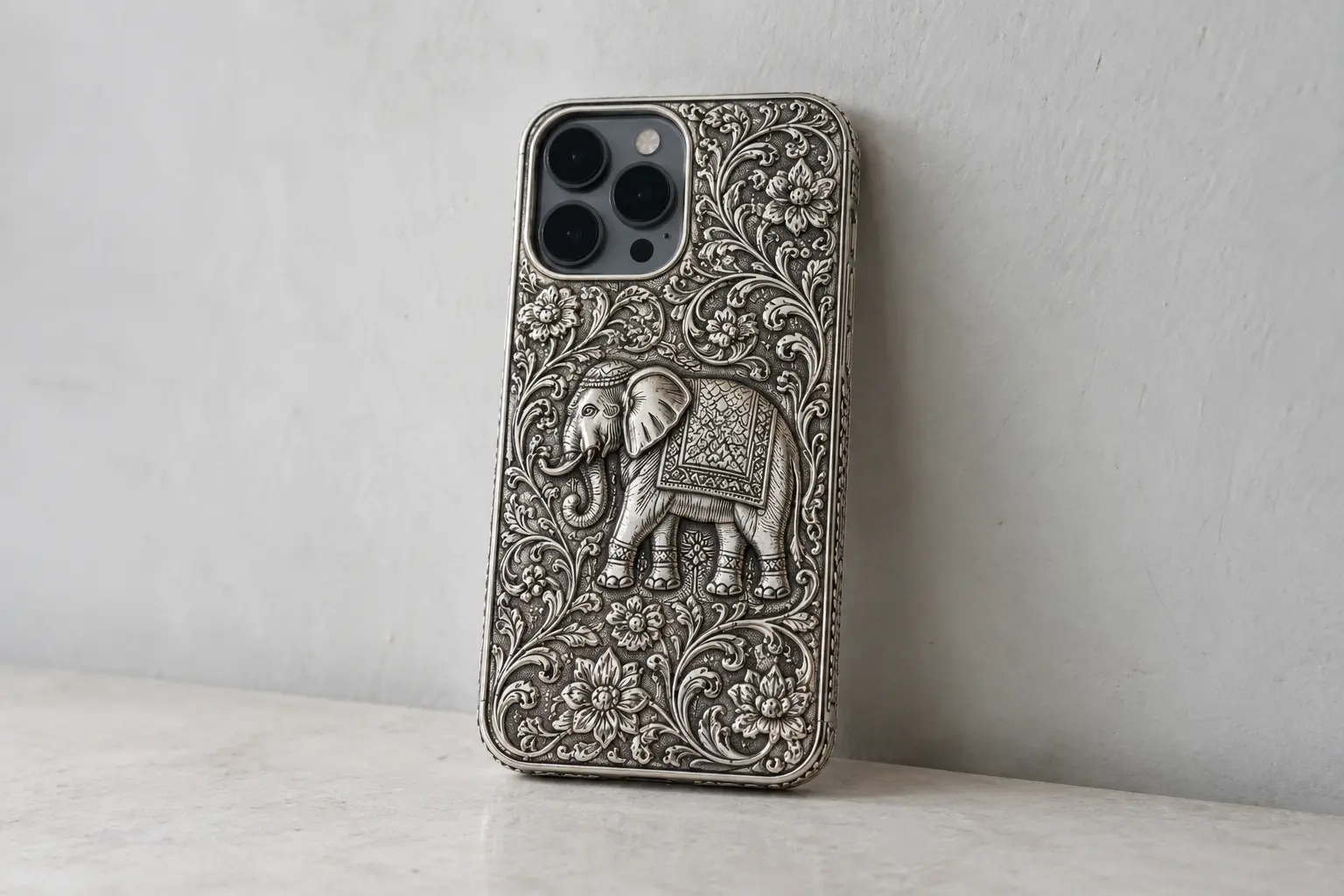 The ₹18,500 silver iPhone back cover featuring an intricate elephant design.
