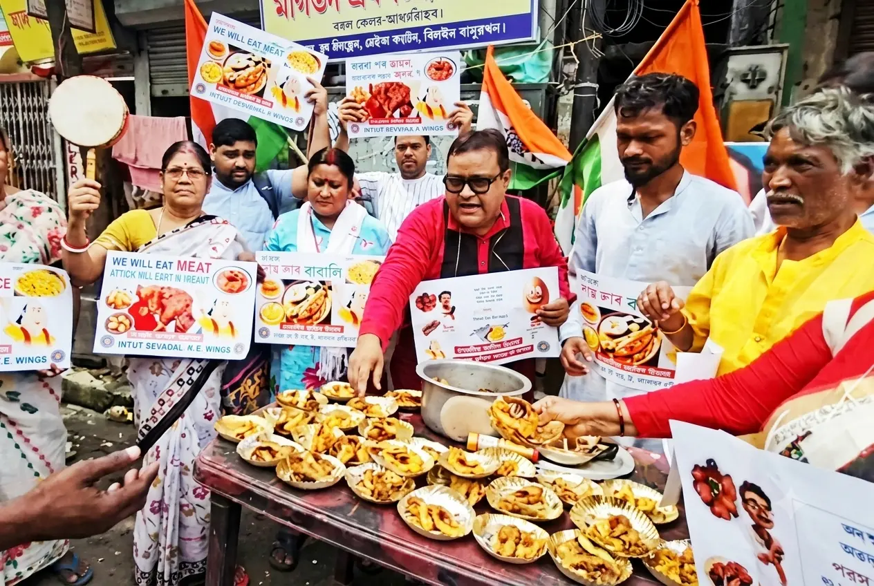 People participate in the 'Bangalir Amish Utsav' in Kolkata, serving fish and meat as part of a protest against religious policing of food choices.
